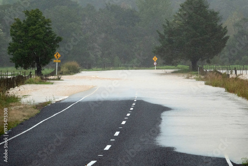 Flooded rural road after heavy rain in Northland New Zealand