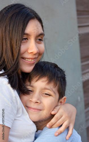 Happy loving little latin siblings.