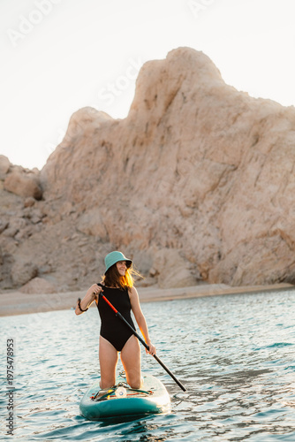 Canvas Print Rucica beach in Metajna on Pag island woman paddleboarding or kayaking at sea wi