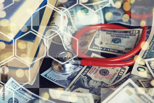 Close up red stethoscope on the US dollar banknote on wooden table. Health check or money and financial concept