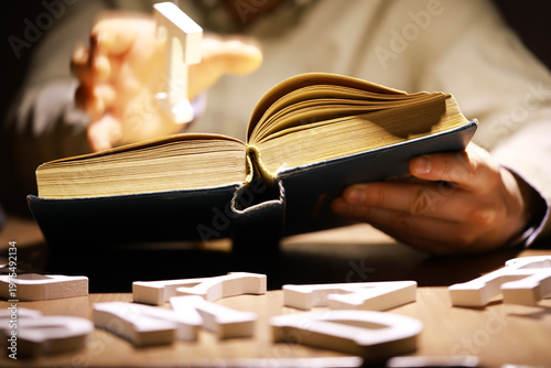Man holding an open book with two hands. Concept of learning, education, knowledge and religion