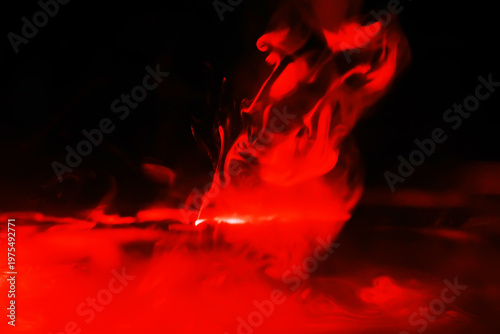 Red smoke over black studio background. Red steam on a black background. Copy space.