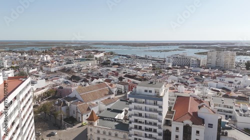 Rising view revealing the cityscape of Faro and its urban layout.