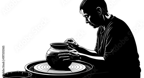 Man working on pottery wheel studio.