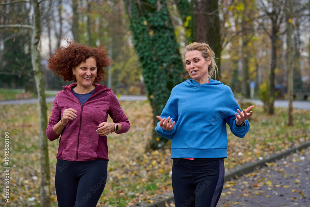 Fototapeta premium Middle aged women jogging in the park