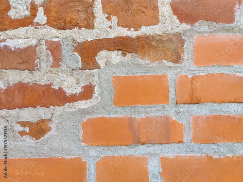 Rough texture background of red brickwork with signs of destruction and wear. Full frame. Close-up