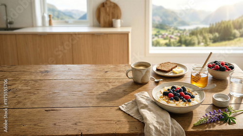 Skyr breakfast with berries and tea on wooden table in bright minimalist kitchen interior. Concept of slow living, calm morning, and mindful healthy lifestyle.