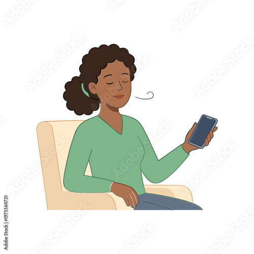 Woman sits on sofa looking at smartphone with relaxed expression