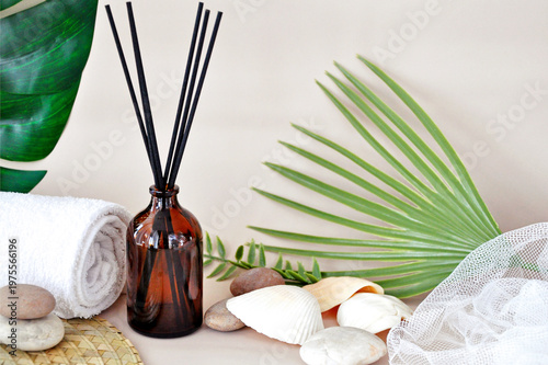 Bottle of Aroma Diffuser with Reed Stick on Tropical concept Background