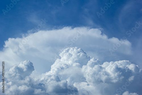 Dramatic cumulonimbus cloud formation with halo arc over blue sky