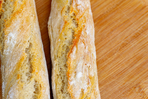 Fresh baked baguette bread on wooden cutting board
