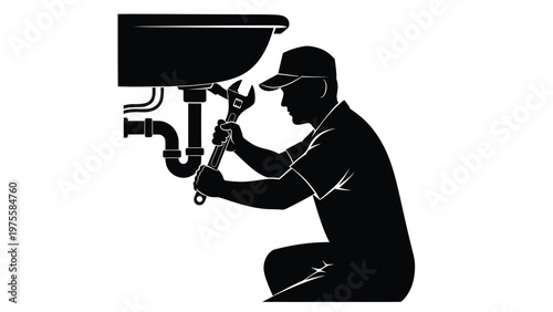 Silhouette of a plumber kneeling under a sink while using a wrench to repair metal pipework