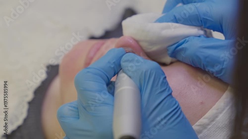 A woman gets a vacuum facial cleansing in a cosmetology room. Cleansing the skin.