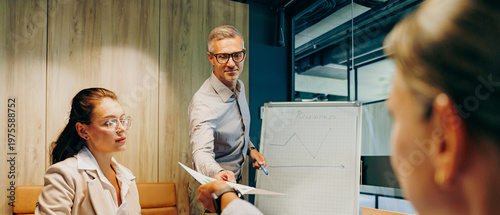 Experienced leader conducts strategy session in contemporary office setting