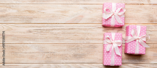 Valentine day composition: red gift box with bow and heart. Christmas present. View from above. Space for text. Holday greeting card