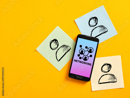 Smartphone showing networking concept surrounded by contacts on sticky notes