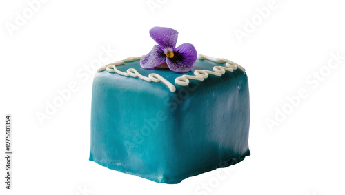Fotografija Teal frosted petit four cake with white icing swirls and purple flower, isolated