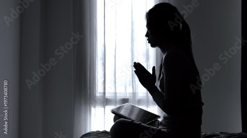 Silhouette of a woman  Praying hands with faith in religion and belief in God. Power of hope or love and devotion. 4K slow-motion video.