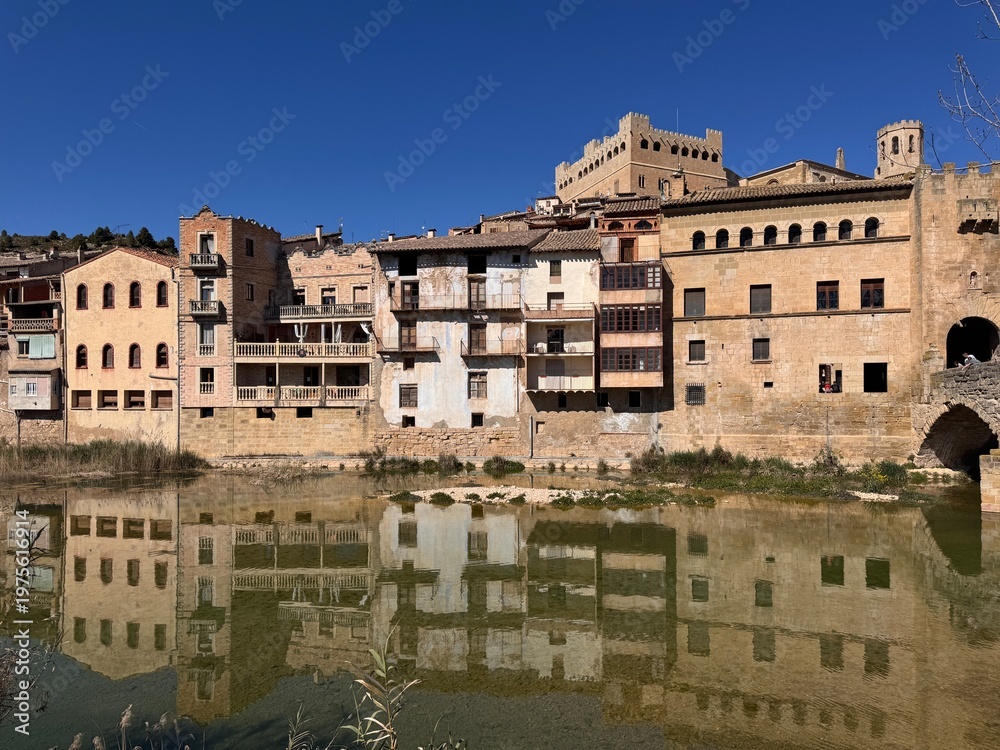 Fototapeta premium Historic town skyline with river reflection and castle in Valderrobres Teruel Spain