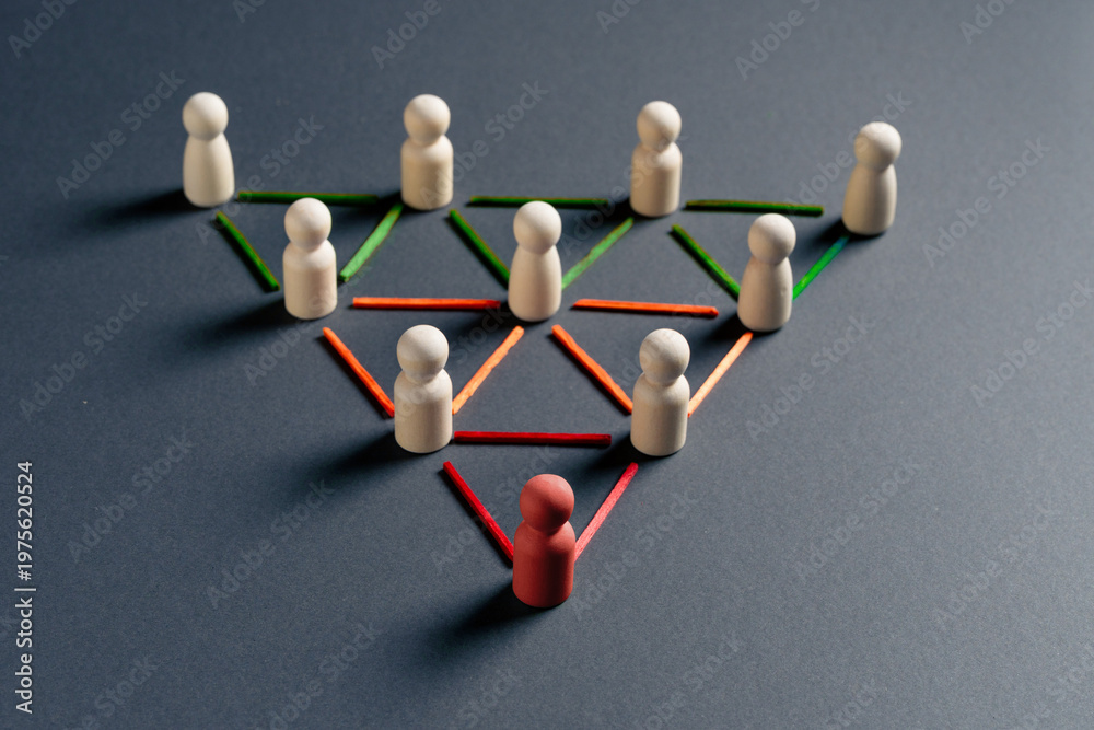 Obraz premium Abstract metaphor of leadership and connected networks using wooden figures and intersecting colorful lines.