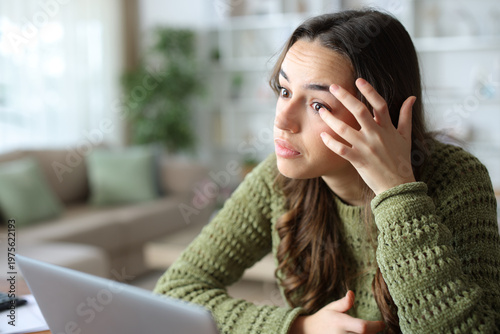 Bild auf Leinwand Woman at home repositioning contact lenses