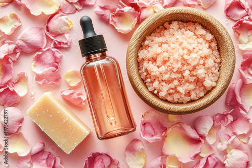 Aromatic bath essentials with pink salt scrub, rose petals, soap, and oil