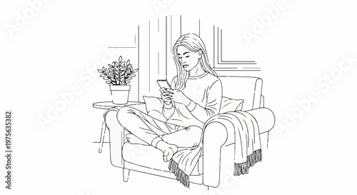 Young woman relaxing in an armchair, engrossed in her mobile phone, cozy blanket