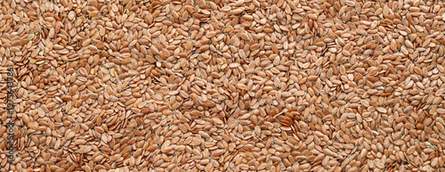 Konstfotografi Brown flax seeds in big pile on table close up
