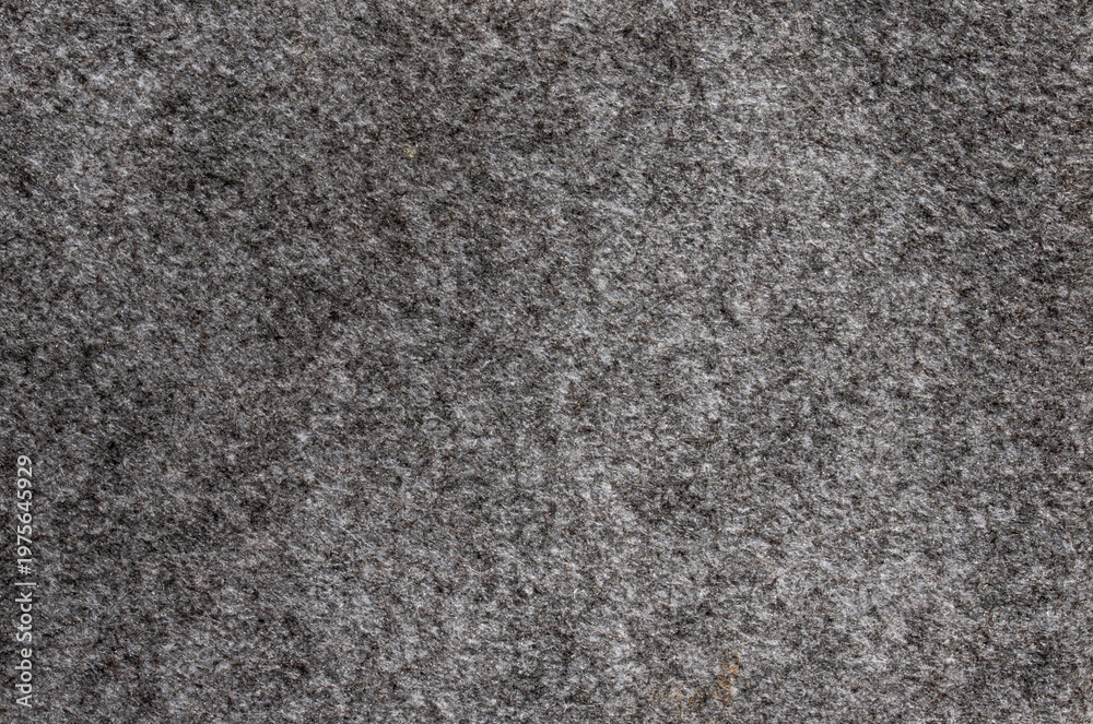 Fototapeta premium Top view of dark grey felt fabric texture with soft fuzzy surface and detailed organic fiber pattern for textile background