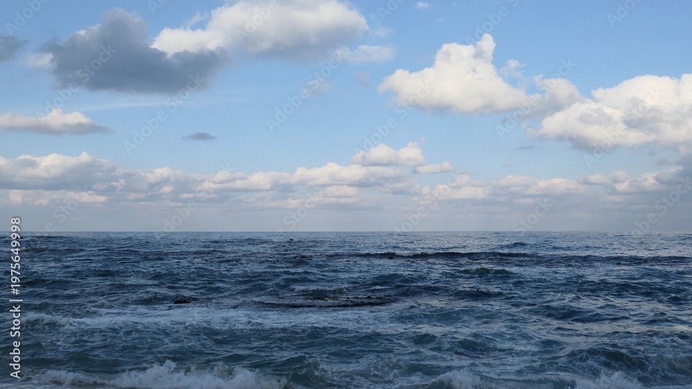 Fototapeta premium Waves and Cloudy Sky at Sacheonjin Beach, Gangneung