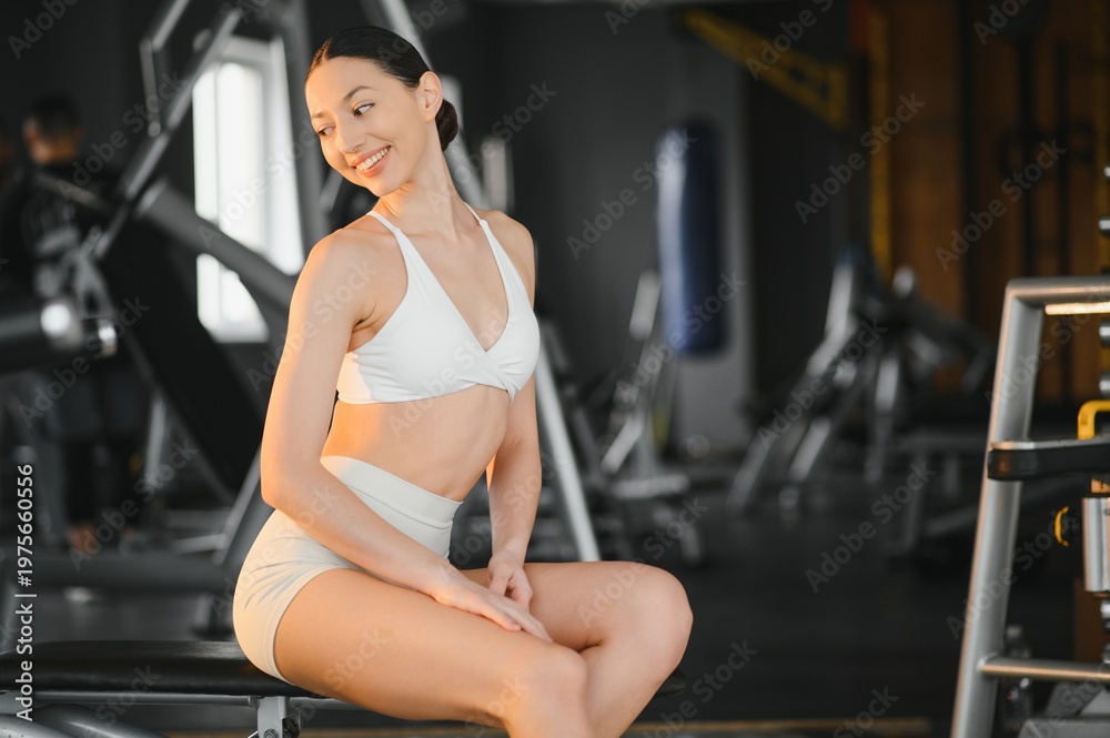 Fototapeta premium Woman smiling and resting enjoying gym workout