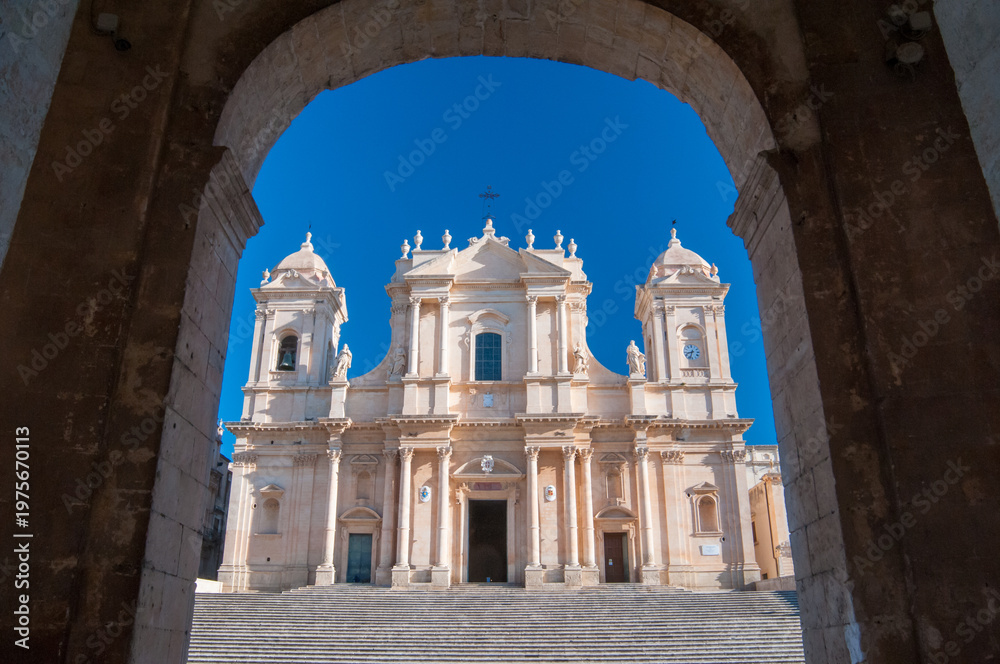 Obraz premium The Cathedral of San Nicolò in Noto, Sicily, seen from Palazzo Ducezio, headquarters of the local administration. The church in one of the best examples of the baroque architecture in the island