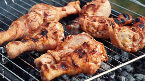 hicken feet marinated grilling on rack over coals, spring barbecue in backyard