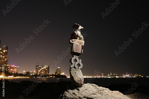 Bild auf Leinwand Zen tower made of stones, wooden pieces and paving blocks balanced on rock again