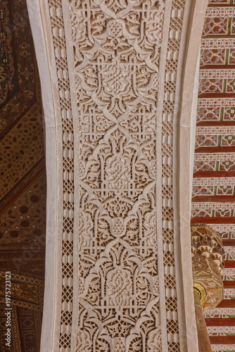 Pointed arch intrados of floral and geometric-carved stucco, doorway from the gallery to a room, Small Courtyard-Bahia Palace. Marrakesh-Morocco-279