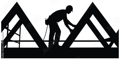 Construction worker in silhouette inspecting roof trusses at building site.
