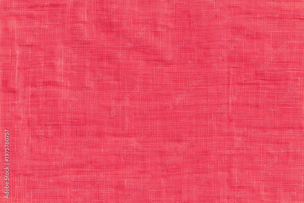 Fototapeta premium Close-up image of a textured pink fabric with a woven pattern, showcasing detailed threads and fibers.