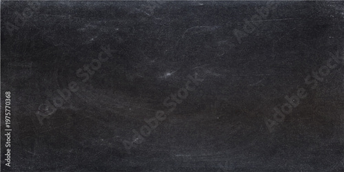 A close-up captures the textured surface of a dark chalkboard, weathered and etched with traces of chalk, ready for ideas to take shape.