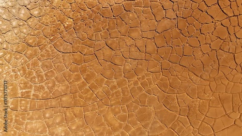 Aerial view of cracked red earth and dry mud patterns in the mining landscape of Minas de Riotinto, Andalusia, Spain.
