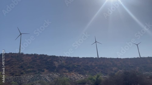 Wind Turbines Under Bright Sun  Renewable Energy Landscape with Clear Sky