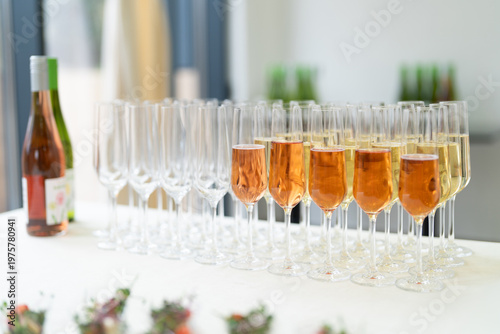 Εκτύπωση καμβά Row of champagne glasses filled with sparkling wine at a catered event