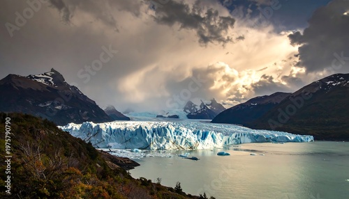 A majestic glacier surrounded by mountains and a serene lake under a dramatic cloudy sky