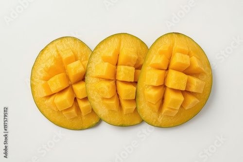 Fresh mango slices arranged on a white background ready for eating or use in recipes