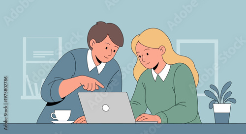 Two colleagues working on laptop at office desk