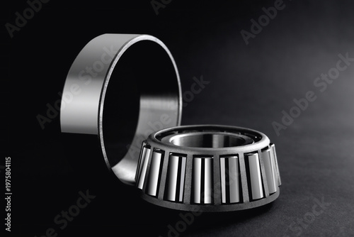 roller bearings on a black background, blank for creativity. Parts for machines and mechanisms in rotation units.