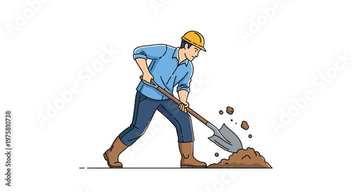 Construction worker in a yellow hard hat and blue shirt using a shovel to dig into a pile of dirt on the ground.