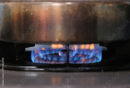 Bilde på lerret Blue flame burning on a gas stove burner under a metal pot