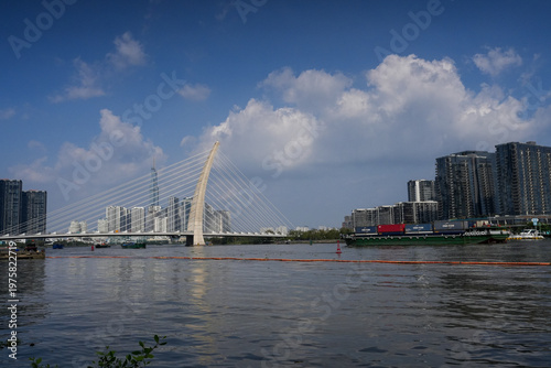 Ba Son Bridge over Saigon River with modern skyline in Ho Chi Minh City, Vietnam