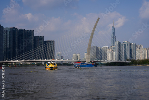 Ba Son Bridge over Saigon River with modern skyline in Ho Chi Minh City, Vietnam