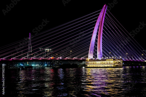 Ba Son Bridge over Saigon River with modern skyline in Ho Chi Minh City, Vietnam